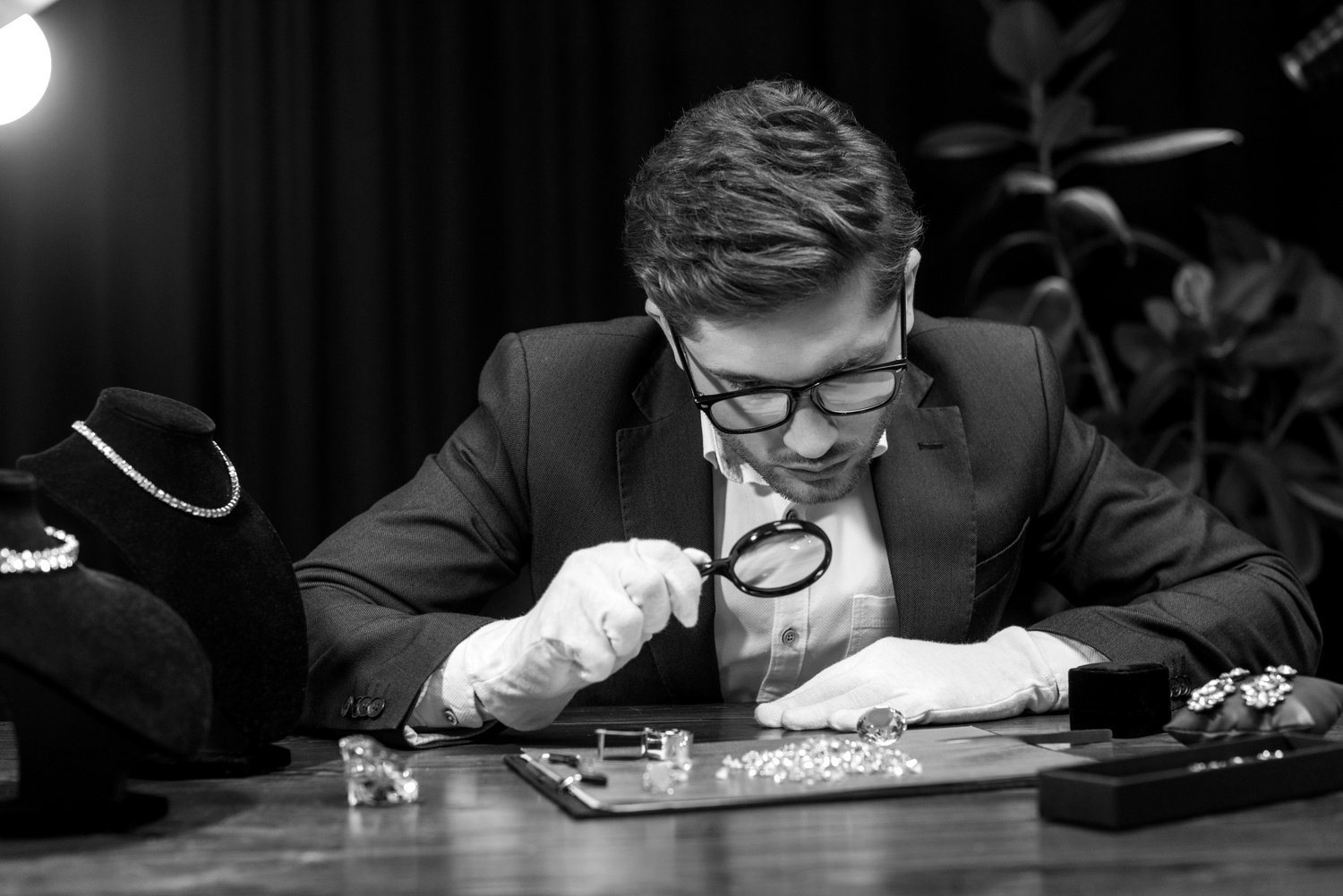 Expert examination of a gemstone with a loupe