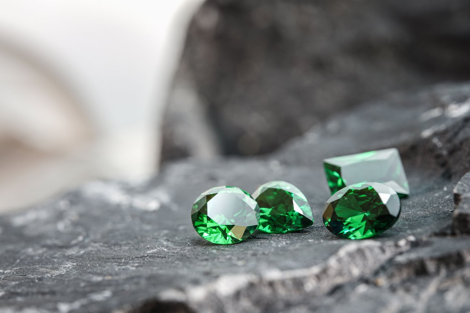 Cut green tsavorites on stone